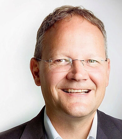 Portrait of a cheerful man with glasses and short hair